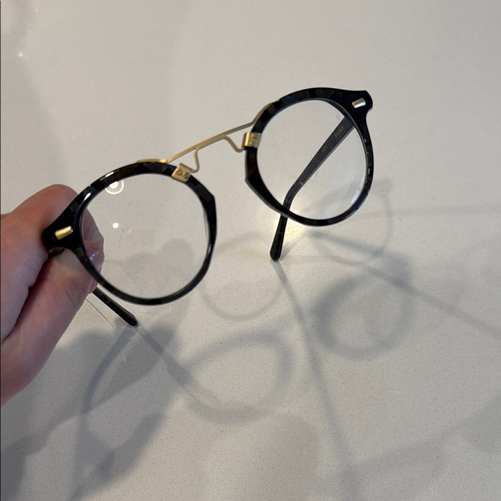 KREWE Black and Gold Round Glasses with Elegant Metal Bridge